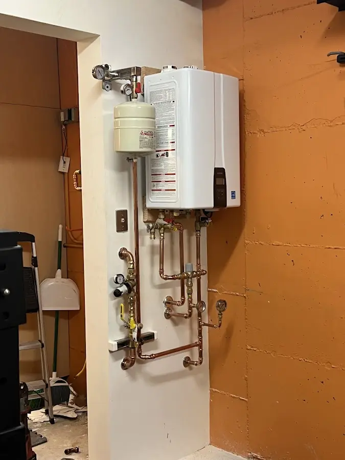 Plumbing technician inspecting water heater connections in Scotts Valley